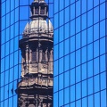 Reflection_of_the_cathedral_bell_tower_in_a_modern_building_at_Santiago.jpg