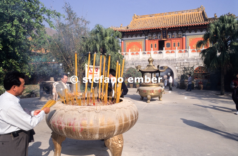 Buddhist believers burn incense in front of Po Lin Monastery 