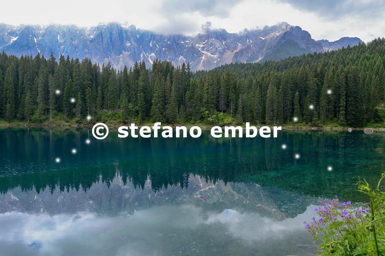 Lake Carezza with reflection of mountains in the Dolomites