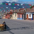 People_walking_in_a_street_with_numerous_flags_at_San_Cristobal_de_las_Casas.jpg