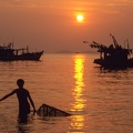 Fisherman_with_a_cage_trap_at_Ha_Tien_on_Vietnams_delta_of_river_Mekong.jpg