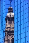Reflection of the cathedral bell tower in a modern building at Santiago