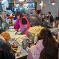people eating at a stand on a market of Seoul