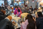 people eating at a stand on a market of Seoul