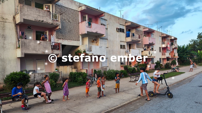 Children_waiting_in_a_row_to_play_with_an_electreic_scooter_at_Vinales.jpg