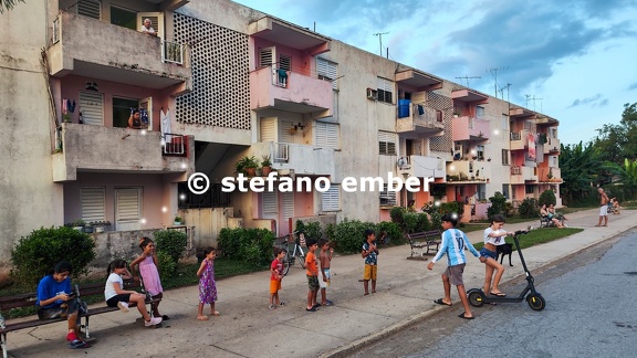 Children waiting in a row to play with an electreic scooter at Vinales