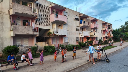 Children waiting in a row to play with an electreic scooter at Vinales