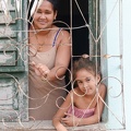 Mom with her daughter at the window in the colonial town of Trinidad