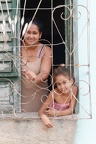 Mom with her daughter at the window in the colonial town of Trinidad