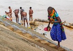 Group of people washing and taking water from Omo river at Kangaten