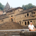 Man doing yoga and meditation in front of Maheshwar palace