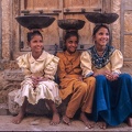 Three girls sitting on the streetside in Jaisalmer