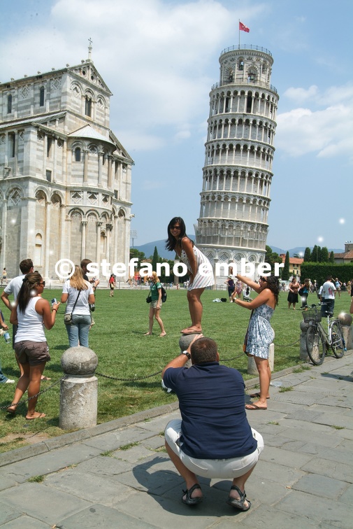Tourists visiting the leaning Tower and Cathedral of Pisa