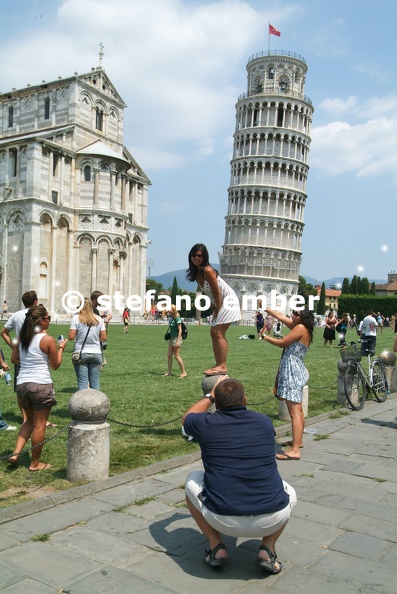 Tourists visiting the leaning Tower and Cathedral of Pisa