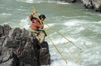 Woman fishing with a rudimentary network in the Mekong river at Don Khon island