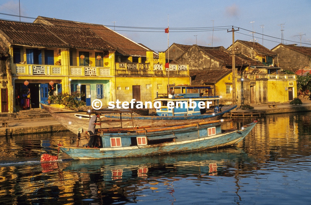 Traditional boat in front of ancient architecture in Hoi An
