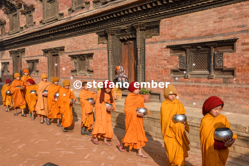 Young Buddhist monks walking in morning alms at Bhaktapur